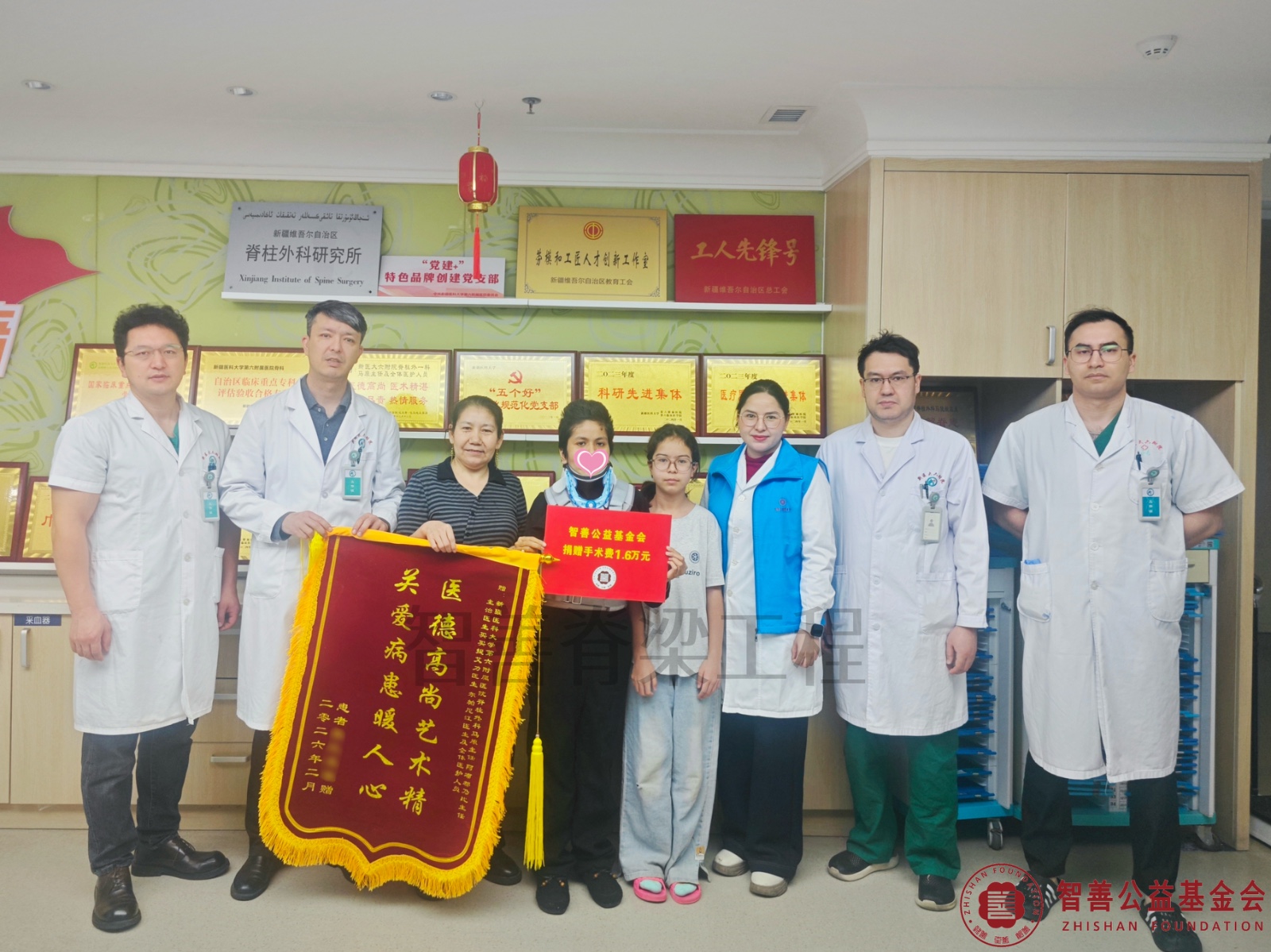14新疆医科大学第六附属医院阿不都乃比·艾力主任（左二）、医生（左起）马俊毅、阿吉古丽、买买提艾力、尔帕尼江将智善公益基金会捐赠的1.6万元转交给新疆阿克苏库车市患者热比亚木.jpg