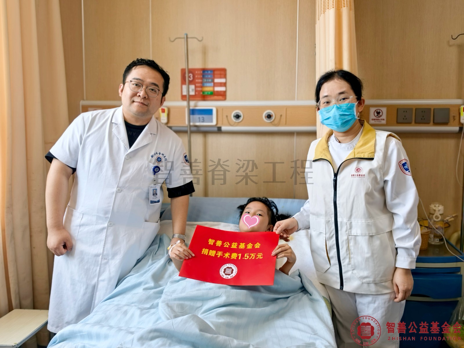 10郑州市骨科医院（左起）刘少峥医生、爱心志愿者孙静娜将智善公益基金会捐赠的1.5万元转交给河南商丘睢县患者蒋笑笑.jpg