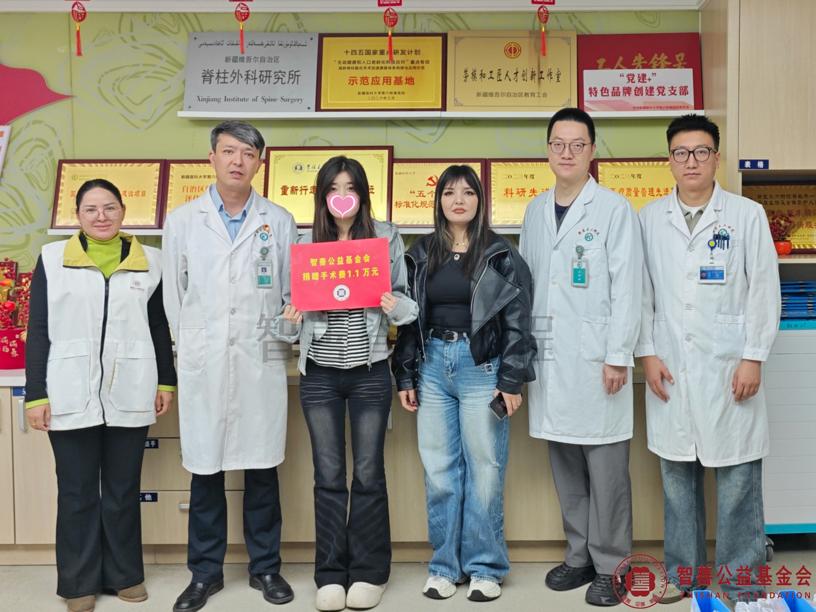 35新疆医科大学第六附属医院阿不都乃比主任（左二）、（左起）爱心志愿者阿吉古丽医生、李栎医生、卡马力别克医生将智善公益基金会捐赠的1.1万元转交给新疆阿克苏拜城县患者阿迪莱.jpg
